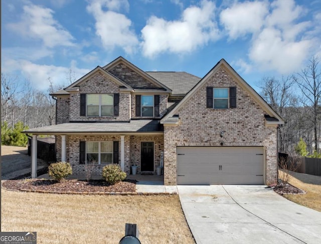 10736 Southwood Dr, Hampton, GA 30228 - view of front of property featuring concrete driveway, brick siding, covered porch, and a garage