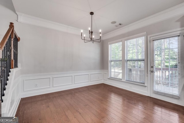 2325 Limehurst Dr NE, Atlanta, GA 30319 - unfurnished dining area featuring a chandelier, crown molding, wainscoting, and dark wood finished floors