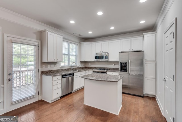 2325 Limehurst Dr NE, Atlanta, GA 30319 - kitchen with appliances with stainless steel finishes, ornamental molding, a sink, white cabinetry, and stone counters