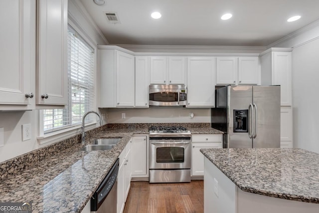 2325 Limehurst Dr NE, Atlanta, GA 30319 - kitchen with appliances with stainless steel finishes, a sink, white cabinetry, stone countertops, and recessed lighting
