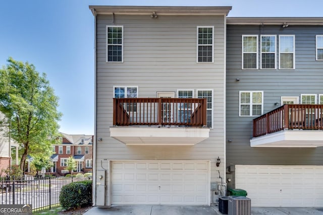 2325 Limehurst Dr NE, Atlanta, GA 30319 - back of property with an attached garage, a balcony, concrete driveway, and central AC unit