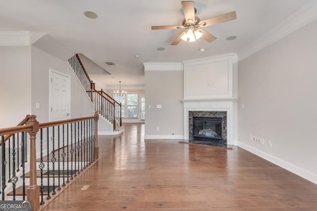 2325 Limehurst Dr NE, Atlanta, GA 30319 - unfurnished living room with crown molding, stairway, wood finished floors, a chandelier, and ceiling fan