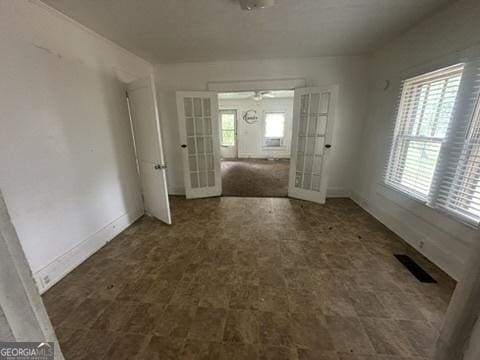 146 Carter St, Carrollton, GA 30117 - spare room with french doors, tile patterned floors, and baseboards