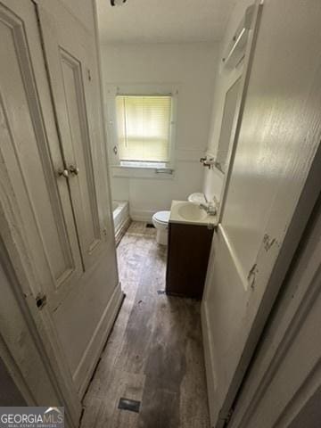 146 Carter St, Carrollton, GA 30117 - full bathroom with vanity, toilet, wood finished floors, and a bath