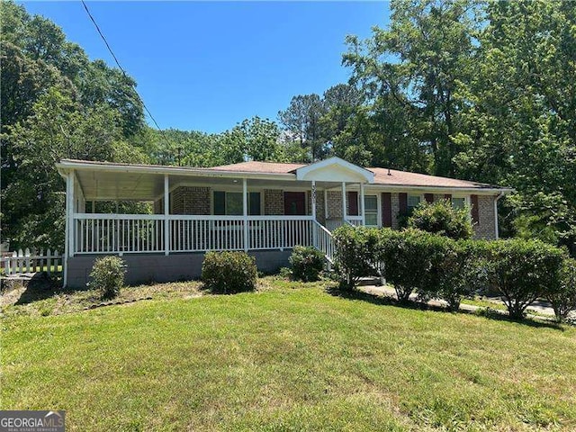 3551 Skyline Ter SW, Marietta, GA 30008 - view of front facade featuring a front yard, covered porch, and brick siding