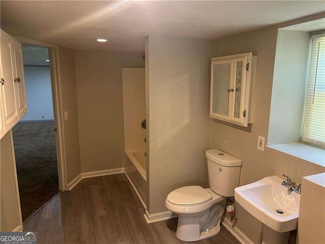 3551 Skyline Ter SW, Marietta, GA 30008 - bathroom featuring toilet, wood finished floors, a bath, and a sink
