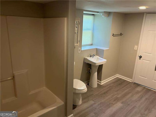 3551 Skyline Ter SW, Marietta, GA 30008 - full bathroom featuring toilet, wood finished floors, baseboards,  shower combination, and a sink