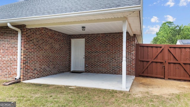 20 Walton Creek Dr SW, Rome, GA 30165 - entrance to property featuring brick siding, a patio area, roof with shingles, and a gate
