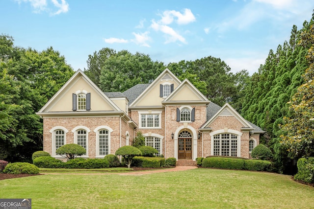 314 Caruso Ct, Sandy Springs, GA 30350 - view of front facade with a front lawn, stucco siding, and brick siding