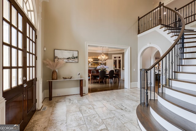 314 Caruso Ct, Sandy Springs, GA 30350 - entryway featuring a high ceiling, plenty of natural light, stairs, a chandelier, and stone tile floors
