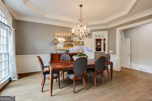 314 Caruso Ct, Sandy Springs, GA 30350 - dining space with a chandelier, wood finished floors, crown molding, a raised ceiling, and a wainscoted wall