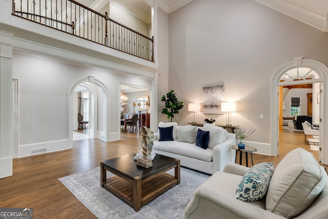 314 Caruso Ct, Sandy Springs, GA 30350 - living area with arched walkways, a high ceiling, wood finished floors, and crown molding