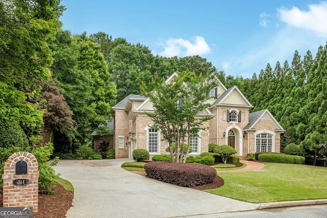 314 Caruso Ct, Sandy Springs, GA 30350 - view of front of property featuring a front lawn, driveway, and brick siding