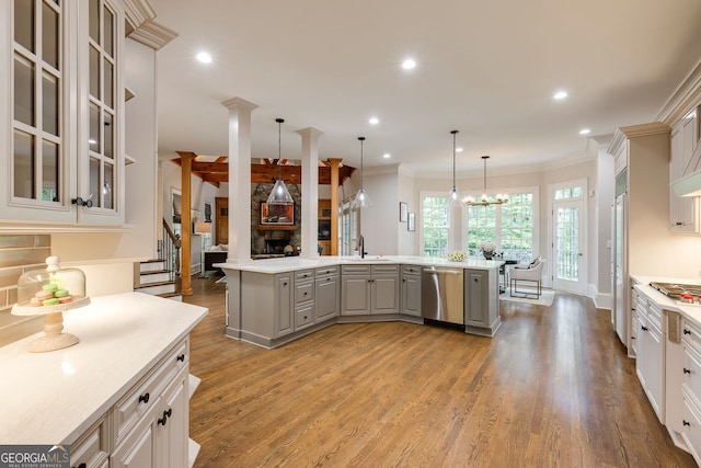 314 Caruso Ct, Sandy Springs, GA 30350 - kitchen with gray cabinetry, appliances with stainless steel finishes, light countertops, light wood-type flooring, and a kitchen island with sink