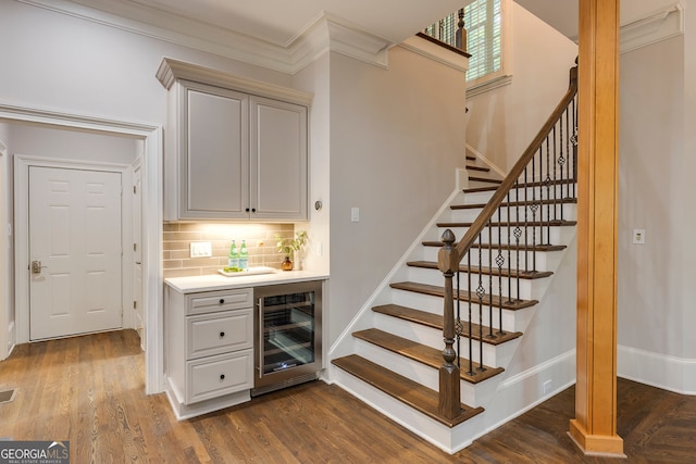 314 Caruso Ct, Sandy Springs, GA 30350 - indoor wet bar with wine cooler, tasteful backsplash, stairway, dark wood-type flooring, and ornamental molding