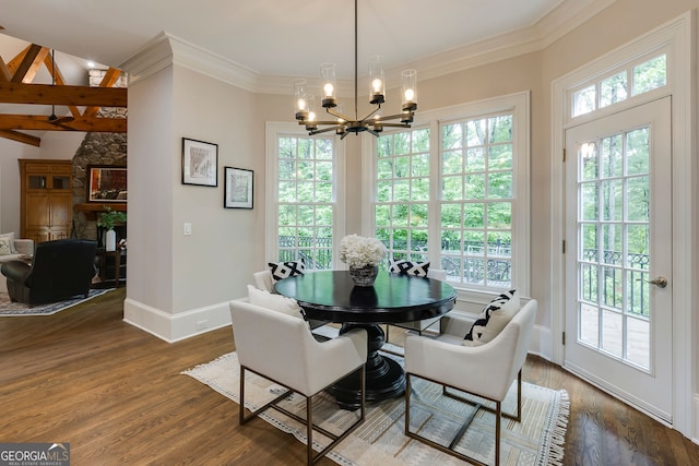 314 Caruso Ct, Sandy Springs, GA 30350 - dining room featuring a chandelier, a stone fireplace, wood finished floors, and ornamental molding
