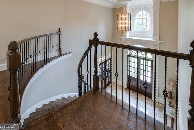 314 Caruso Ct, Sandy Springs, GA 30350 - staircase with a chandelier, ornamental molding, a towering ceiling, and wood finished floors