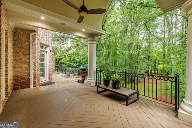 314 Caruso Ct, Sandy Springs, GA 30350 - wooden terrace with ceiling fan, outdoor dining area, and view of wooded area