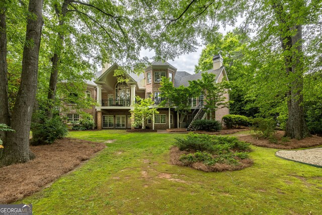 314 Caruso Ct, Sandy Springs, GA 30350 - rear view of property featuring a chimney, a lawn, brick siding, french doors, and a balcony