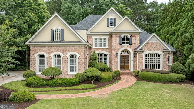314 Caruso Ct, Sandy Springs, GA 30350 - georgian-style home featuring stucco siding, a front yard, brick siding, and french doors