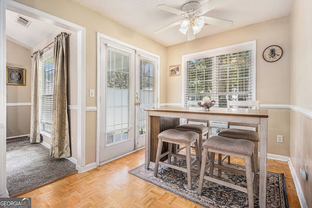 7008 Glen Valley Way, Fairburn, GA 30213 - dining area with healthy amount of natural light, ceiling fan, a textured ceiling, and baseboards