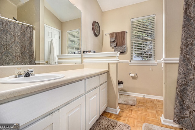 7008 Glen Valley Way, Fairburn, GA 30213 - full bathroom with toilet, vanity, baseboards, and vaulted ceiling