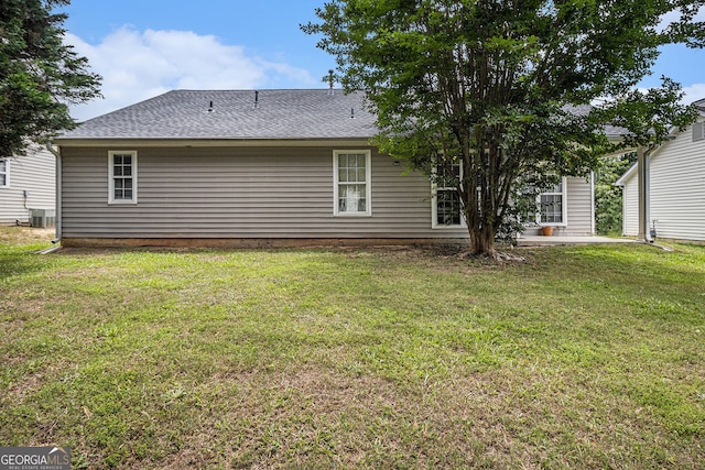 7008 Glen Valley Way, Fairburn, GA 30213 - rear view of house featuring a lawn, roof with shingles, and a patio area