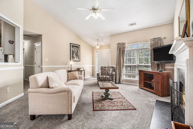 7008 Glen Valley Way, Fairburn, GA 30213 - carpeted living area featuring a ceiling fan, a fireplace with flush hearth, vaulted ceiling, a textured ceiling, and baseboards