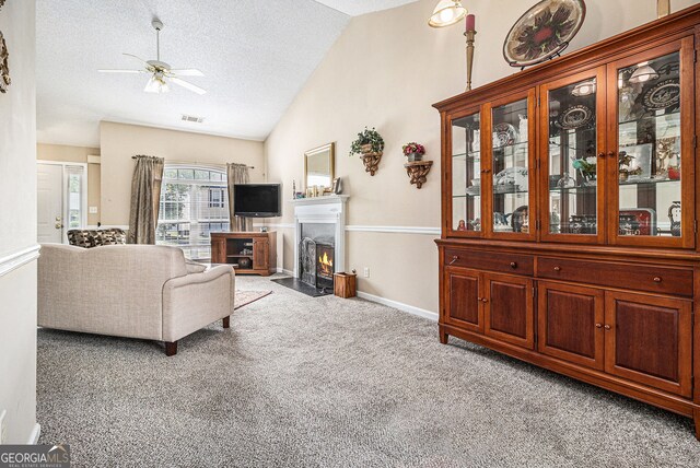 7008 Glen Valley Way, Fairburn, GA 30213 - living room with a ceiling fan, lofted ceiling, light carpet, a textured ceiling, and a fireplace with flush hearth
