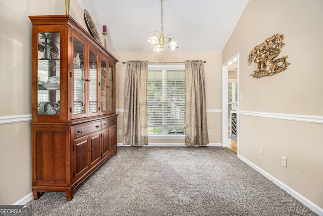 7008 Glen Valley Way, Fairburn, GA 30213 - unfurnished dining area with a chandelier, carpet flooring, baseboards, and a textured ceiling