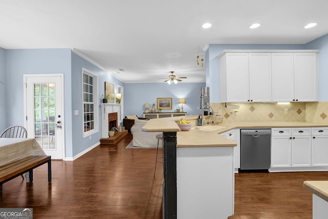 4218 Sandy Branch Dr, Buford, GA 30519 - kitchen featuring stainless steel dishwasher, a sink, a peninsula, open floor plan, and decorative backsplash
