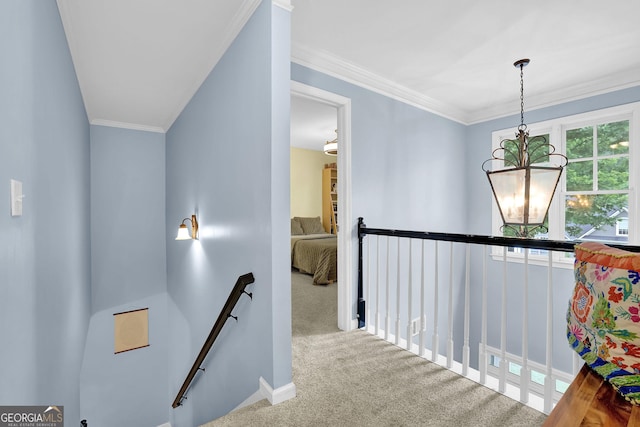4218 Sandy Branch Dr, Buford, GA 30519 - hall with an upstairs landing, carpet floors, a chandelier, baseboards, and crown molding