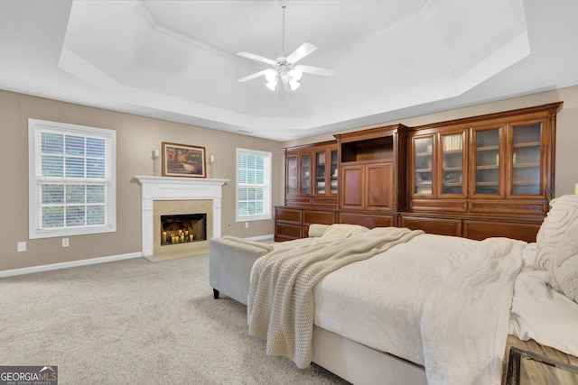 4218 Sandy Branch Dr, Buford, GA 30519 - bedroom with a raised ceiling, a high end fireplace, light carpet, baseboards, and ceiling fan