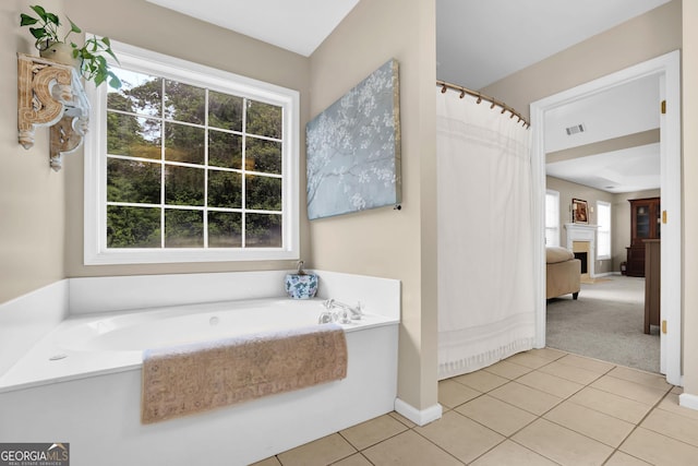 4218 Sandy Branch Dr, Buford, GA 30519 - full bathroom featuring a fireplace, tile patterned floors, a garden tub, and curtained shower