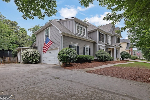 4218 Sandy Branch Dr, Buford, GA 30519 - view of side of property with board and batten siding, concrete driveway, and an attached garage