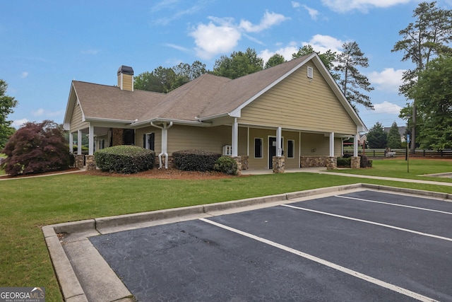 4218 Sandy Branch Dr, Buford, GA 30519 - view of front of house with uncovered parking, covered porch, a chimney, a shingled roof, and stone siding
