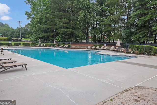 4218 Sandy Branch Dr, Buford, GA 30519 - community pool with a patio area and view of wooded area