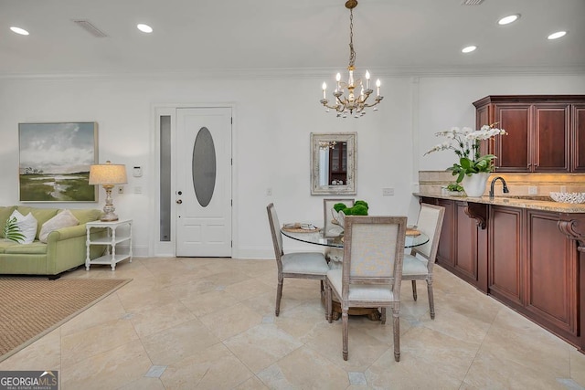 3100 Prince Ln, Saint Simons, GA 31522 - dining room with a chandelier, crown molding, recessed lighting, and baseboards
