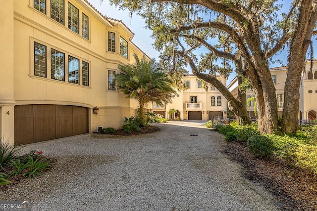 3100 Prince Ln, Saint Simons, GA 31522 - view of front of home featuring gravel driveway and an attached garage