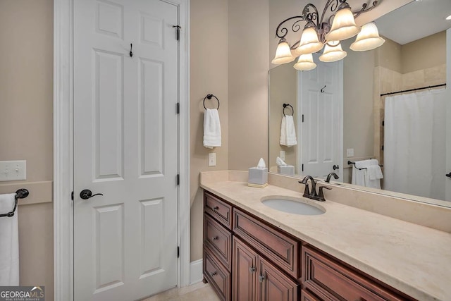 3100 Prince Ln, Saint Simons, GA 31522 - bathroom featuring vanity, a chandelier, and a shower with shower curtain