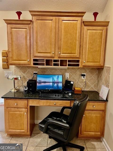 1535 Duluth Hwy Unit 1101, Lawrenceville, GA 30043 - kitchen with light tile patterned flooring, decorative backsplash, dark stone counters, and baseboards