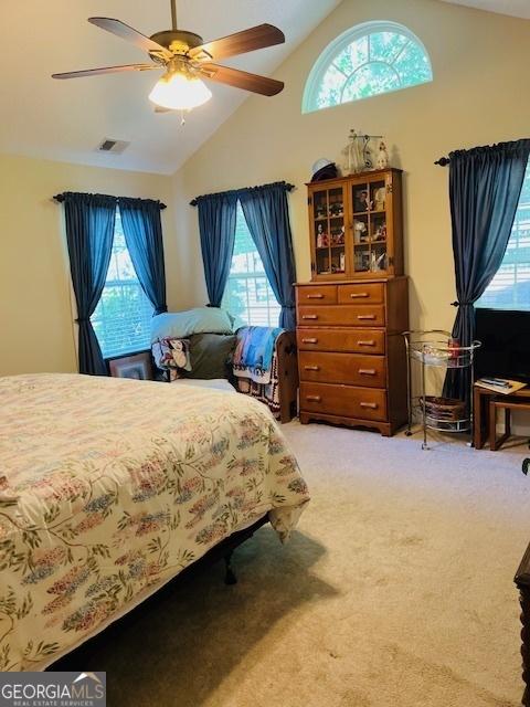 1535 Duluth Hwy Unit 1101, Lawrenceville, GA 30043 - bedroom with multiple windows, light colored carpet, ceiling fan, and high vaulted ceiling