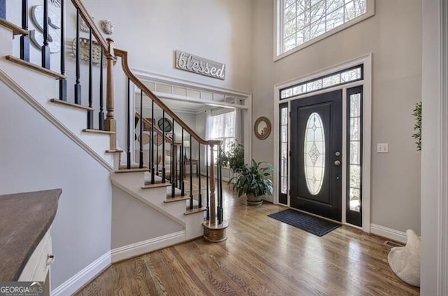 5327 Saville Dr NW, Acworth, GA 30101 - foyer entrance with plenty of natural light, a towering ceiling, wood finished floors, and stairway