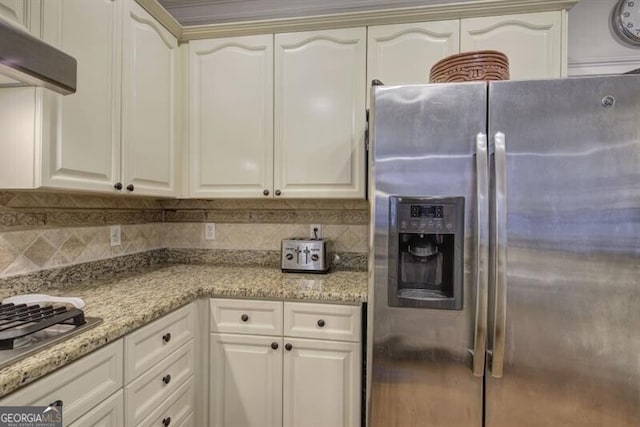 5327 Saville Dr NW, Acworth, GA 30101 - kitchen with stainless steel refrigerator with ice dispenser, under cabinet range hood, tasteful backsplash, and light stone countertops