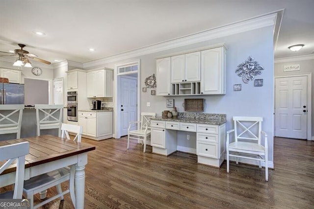 5327 Saville Dr NW, Acworth, GA 30101 - kitchen with ornamental molding, appliances with stainless steel finishes, a ceiling fan, white cabinets, and dark wood-type flooring