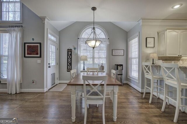 5327 Saville Dr NW, Acworth, GA 30101 - dining area featuring vaulted ceiling and dark wood-style flooring