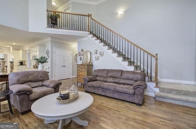5327 Saville Dr NW, Acworth, GA 30101 - living area with stairway, ornamental molding, wood finished floors, and a high ceiling