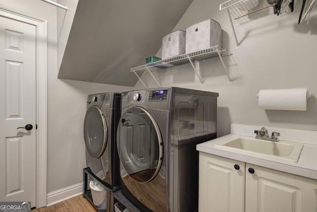5327 Saville Dr NW, Acworth, GA 30101 - laundry room with washing machine and dryer, cabinet space, and light wood finished floors