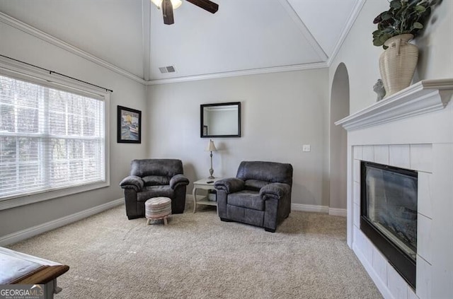 5327 Saville Dr NW, Acworth, GA 30101 - living area featuring carpet flooring, a ceiling fan, a tiled fireplace, ornamental molding, and high vaulted ceiling