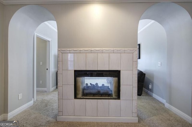 5327 Saville Dr NW, Acworth, GA 30101 - detailed view of a multi sided fireplace, carpet flooring, arched walkways, and crown molding